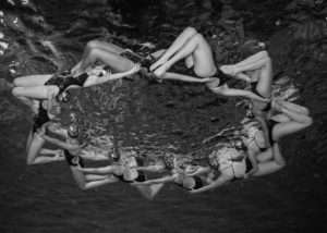 Syncronized swim team round group photo underwater